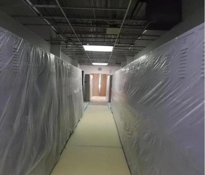 School lockers covered with plastic, long hallway